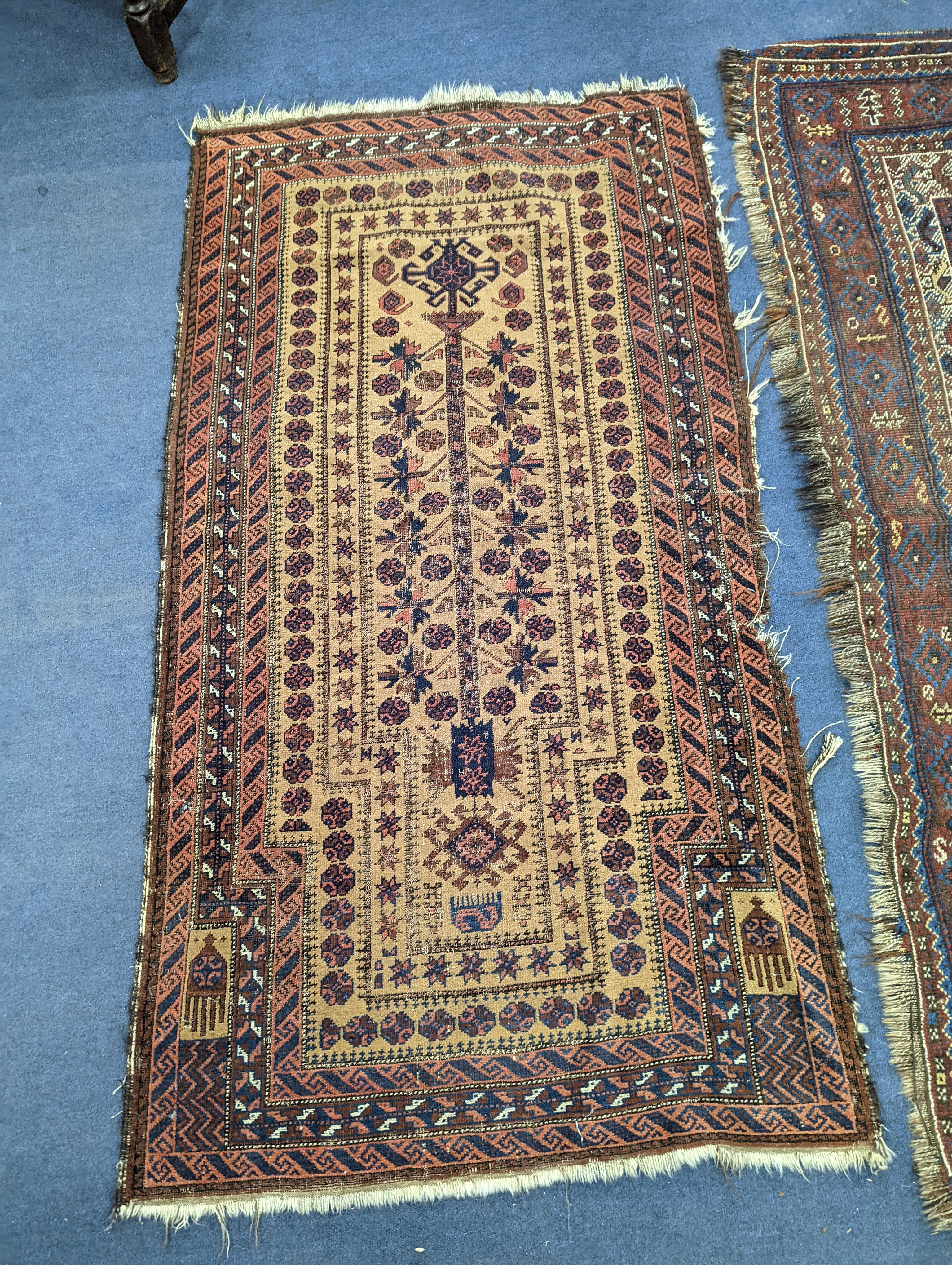 A Caucasian red ground rug and a Belouch rug, larger 200 x 165cm